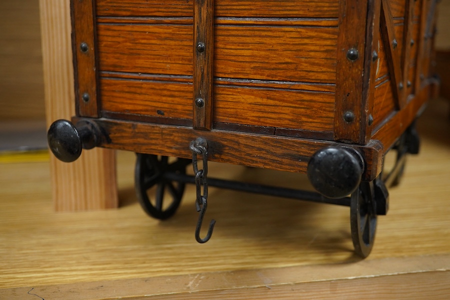 A late 19th or early 20th century novelty cigar box in the form of a railway coal wagon in Great Eastern Railway livery, of oak construction with sectioned interior, integrated match striker, and dummy coal load hiding t